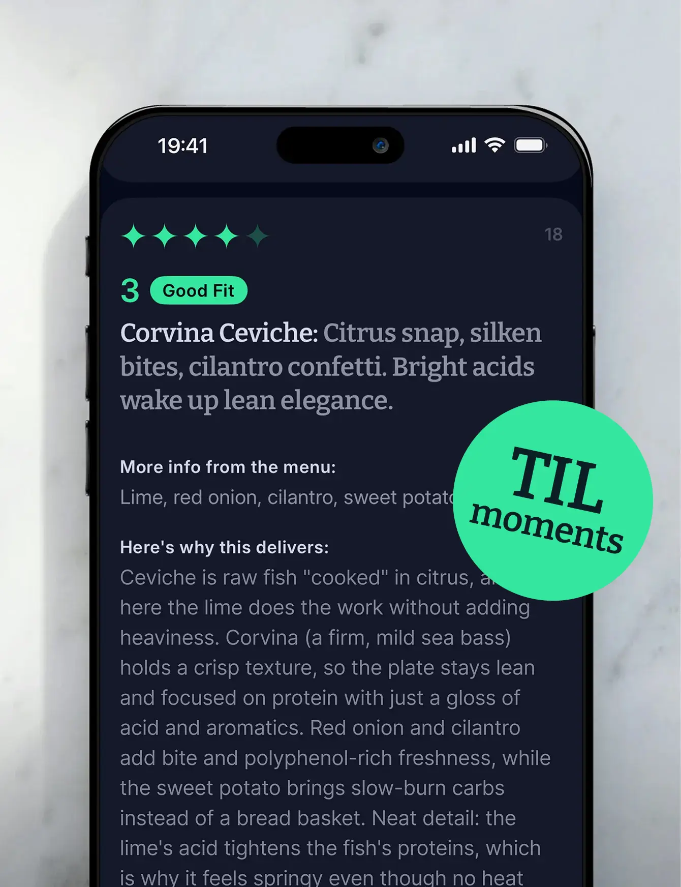 A phone on a marble surface showing the Corvina Ceviche dish card